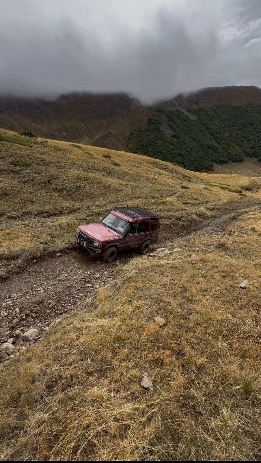 Land Rover 4x4 vehicle descending a steep rocky mountain trail in the Korabi range, Albania