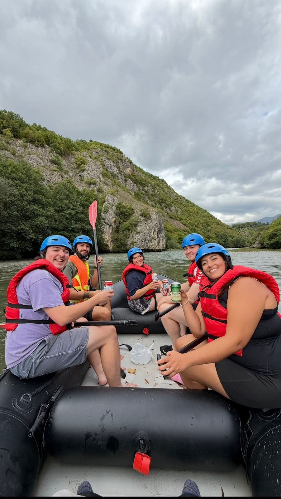 Group river rafting on the Black Drin River in Albania wearing helmets and life vests